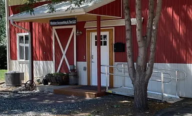 Exterior of the Windsor Accounting & Tax LLC office, a red barn-style building in Windsor, Colorado